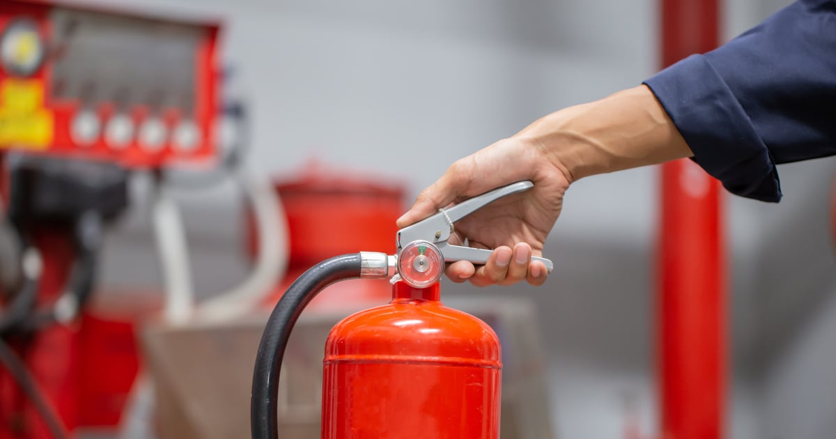 Engineer are checking and inspection a fire extinguishers tank in the fire control room for safety training and fire prevention.